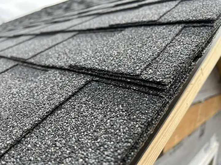 Close-up of clean asphalt shingle texture and granules at a roof edge