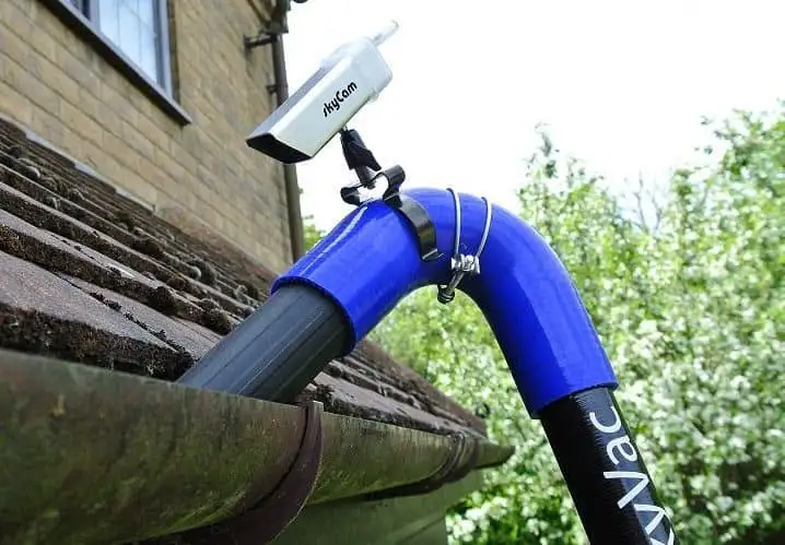 Gutter Cleaning in Dallas, TX 7 Ground level vacuum tube used for gutter cleaning inspection