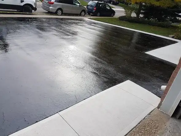 Freshly sealed concrete driveway with a glossy protective finish