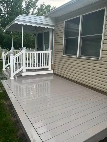 Composite decking cleaned near a covered porch entrance