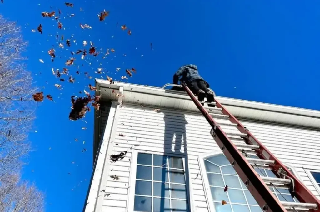 Gutter Cleaning in Dallas, TX 5 Gutter cleaning Dallas crew clearing leaves from a two story home