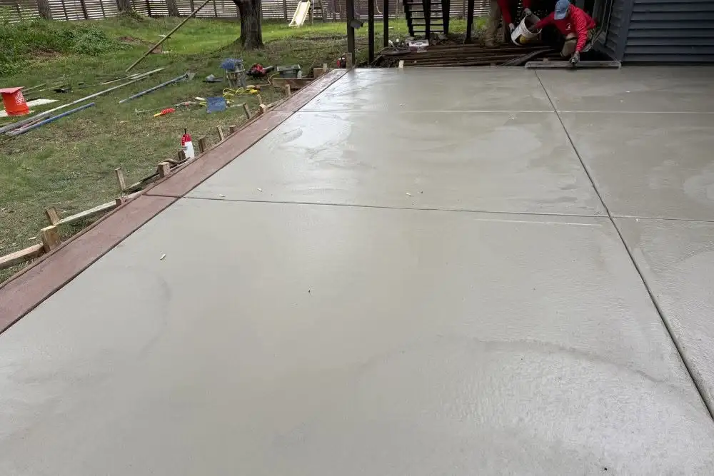 Freshly finished concrete patio being installed outdoors